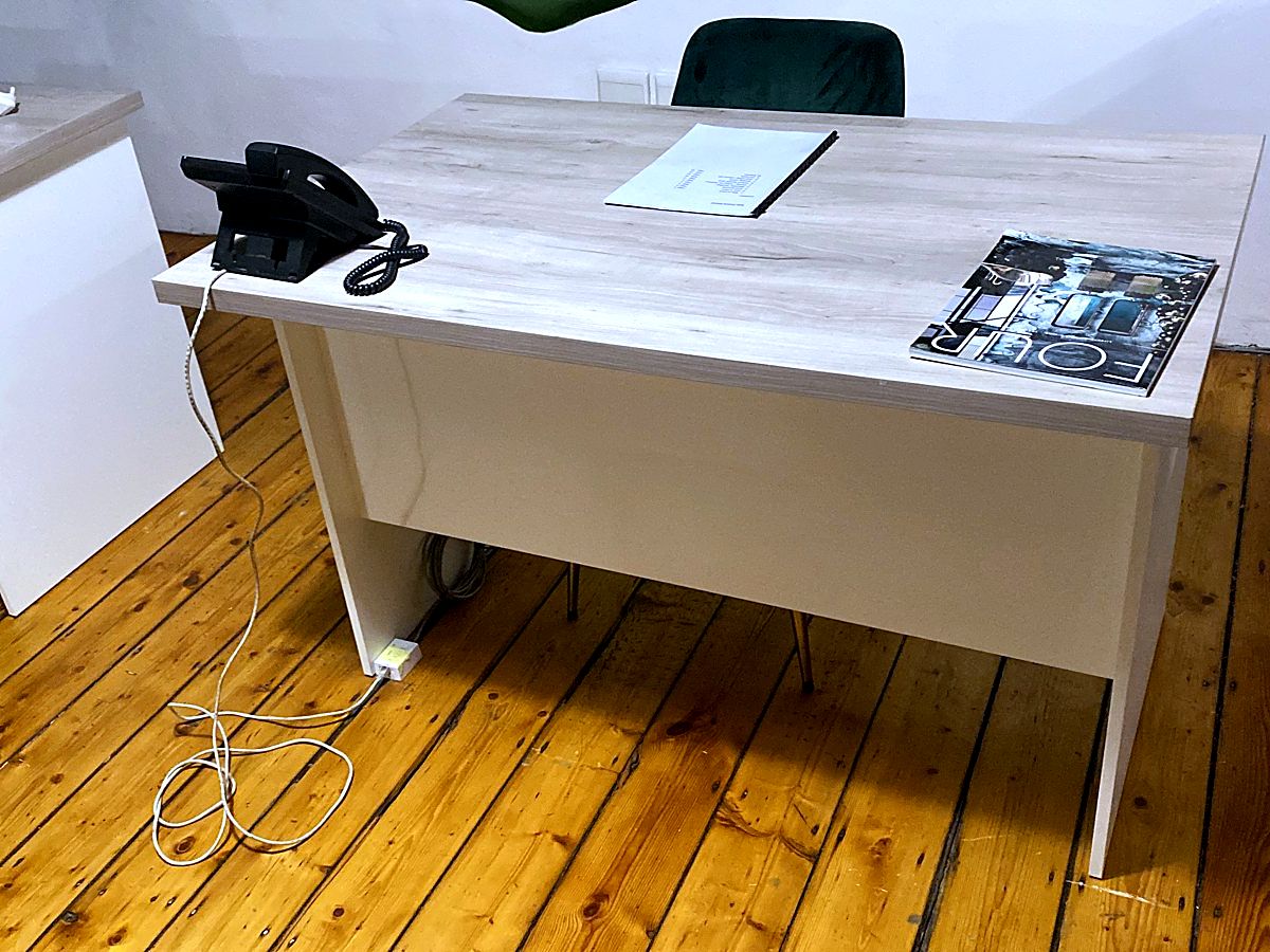 Office desk with a VoIP desk phone connected to a new network point