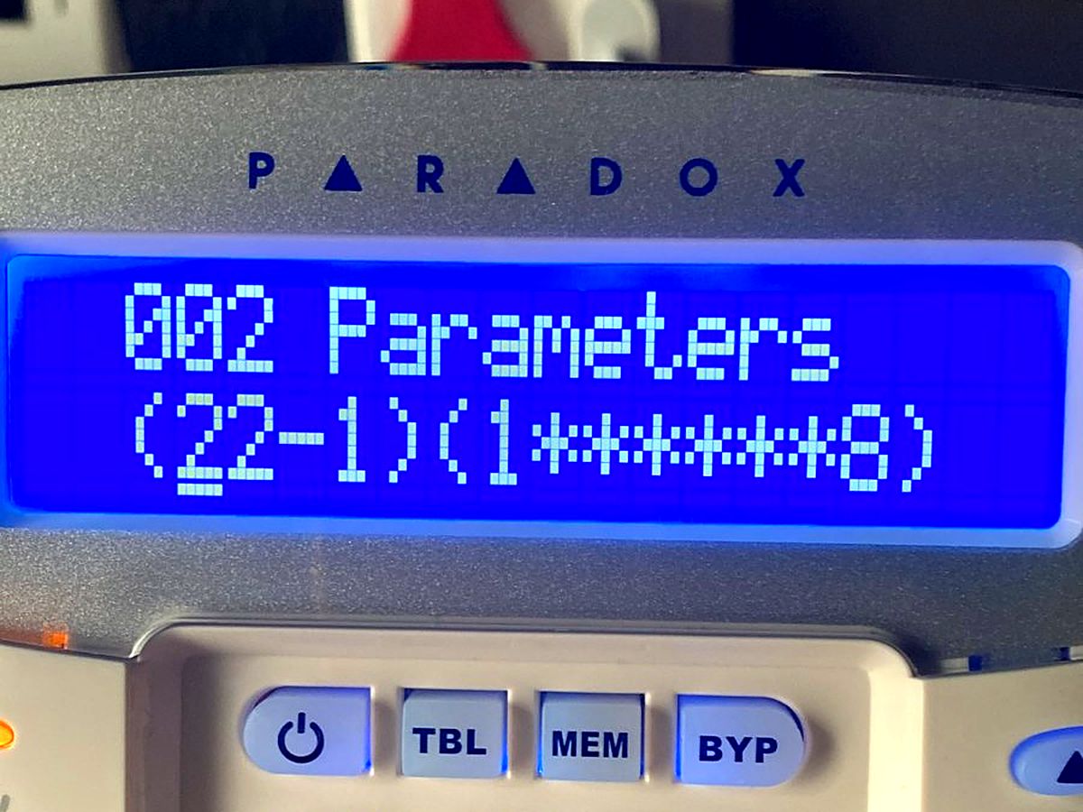 Paradox alarm keypad with a blue LCD screen during programming